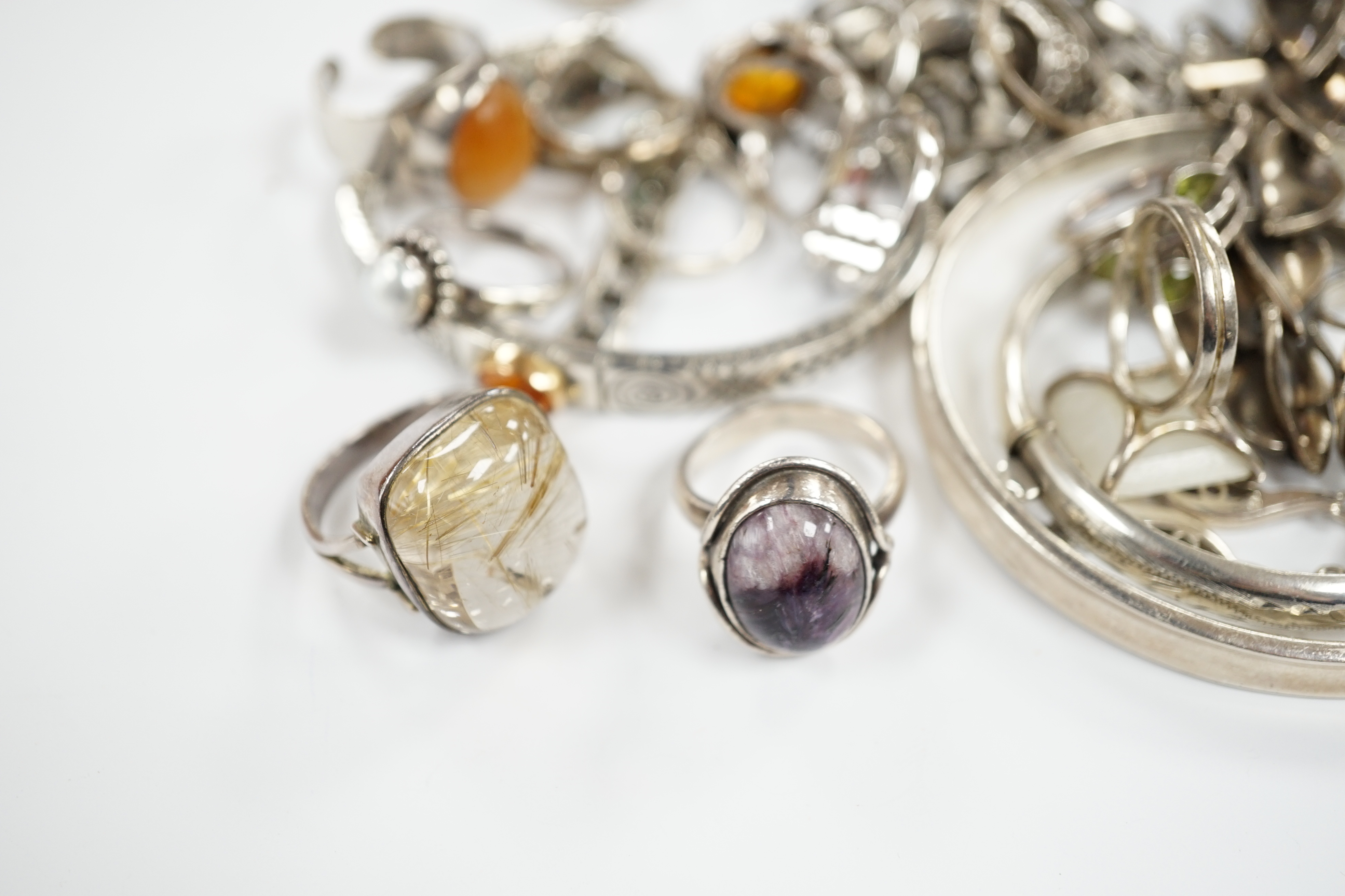 A collection of 925 and white metal rings, bangles and necklaces.